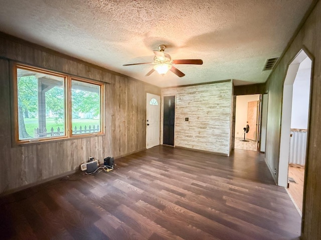 206 William St, Fulton, OH 43321 - unfurnished room featuring wood finished floors, a textured ceiling, a ceiling fan, and wood walls