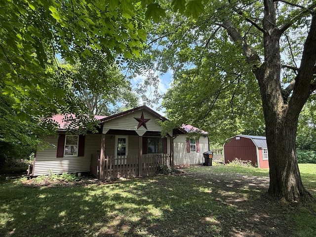 206 William St, Fulton, OH 43321 - view of front of home featuring a shed, a front yard, and a porch