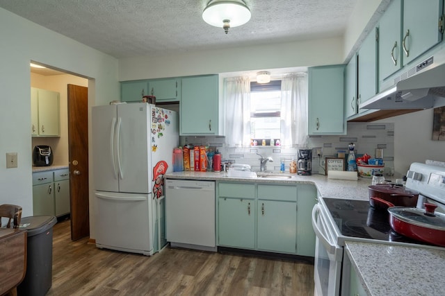 3709 Juniper St, Grove City, OH 43123 - kitchen featuring white appliances, under cabinet range hood, dark wood finished floors, light countertops, and tasteful backsplash