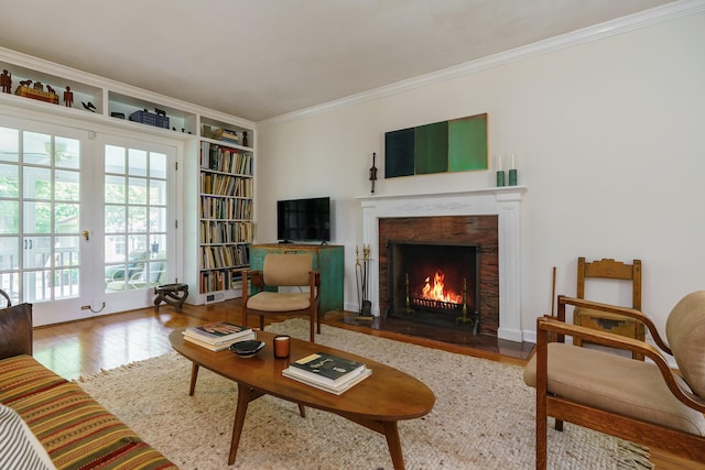 1010 Vernon Rd, Columbus, OH 43209 - living room with wood finished floors, ornamental molding, a fireplace with flush hearth, and built in shelves