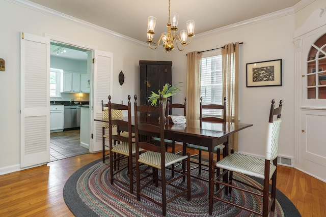 1010 Vernon Rd, Columbus, OH 43209 - dining room featuring a chandelier, light wood-type flooring, and crown molding