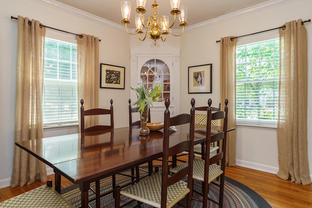 1010 Vernon Rd, Columbus, OH 43209 - dining space with a chandelier, wood finished floors, and crown molding