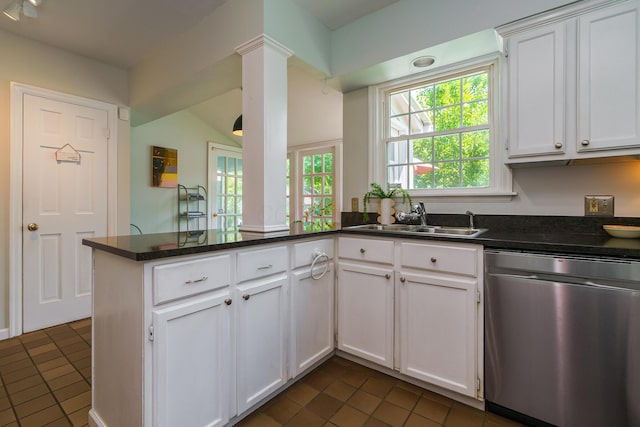 1010 Vernon Rd, Columbus, OH 43209 - kitchen featuring dishwasher, dark tile patterned flooring, decorative columns, and white cabinetry