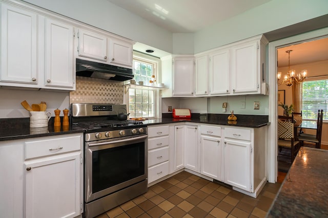 1010 Vernon Rd, Columbus, OH 43209 - kitchen with stainless steel range with gas cooktop, under cabinet range hood, white cabinets, a chandelier, and dark tile patterned floors