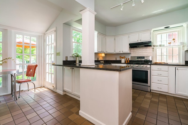 1010 Vernon Rd, Columbus, OH 43209 - kitchen with dark countertops, stainless steel gas range oven, dark tile patterned flooring, white cabinetry, and a peninsula