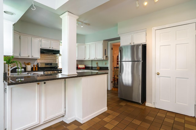 1010 Vernon Rd, Columbus, OH 43209 - kitchen featuring rail lighting, appliances with stainless steel finishes, a peninsula, dark countertops, and white cabinetry