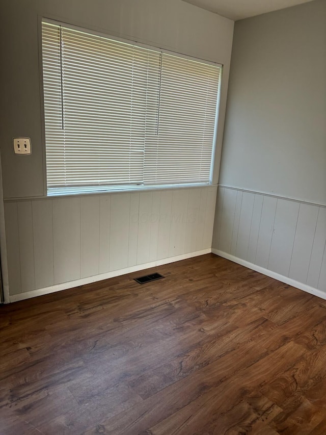 1115 Bermuda Dr, Marion, OH 43302 - spare room featuring dark wood-style flooring and a wainscoted wall