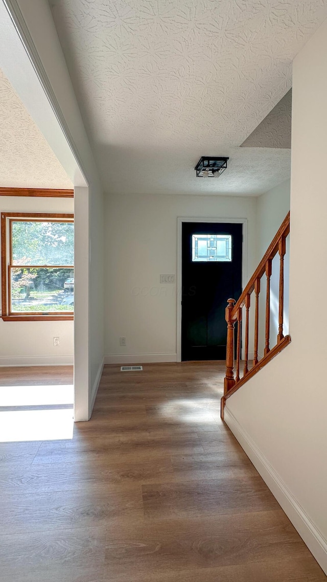 5078 Grassland Dr, Dublin, OH 43016 - foyer with a textured ceiling, wood finished floors, and stairs