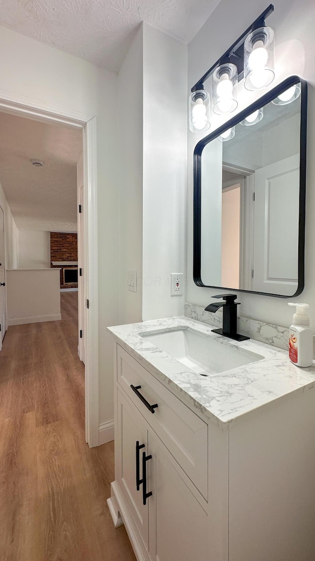 5078 Grassland Dr, Dublin, OH 43016 - bathroom with wood finished floors, vanity, and a textured ceiling