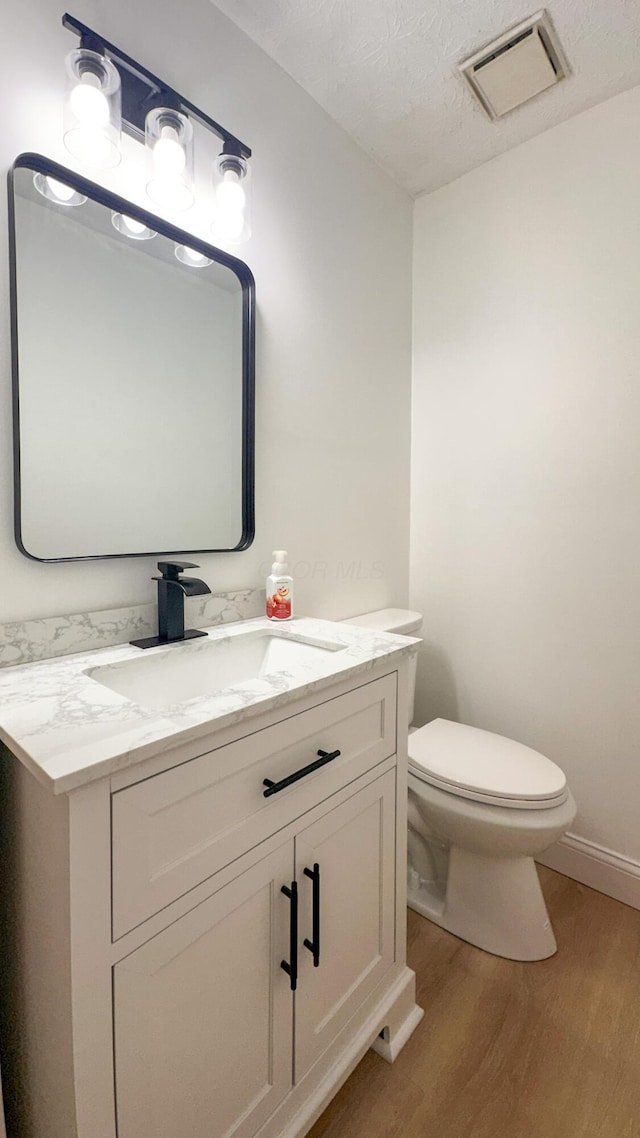 5078 Grassland Dr, Dublin, OH 43016 - half bathroom featuring wood finished floors and vanity