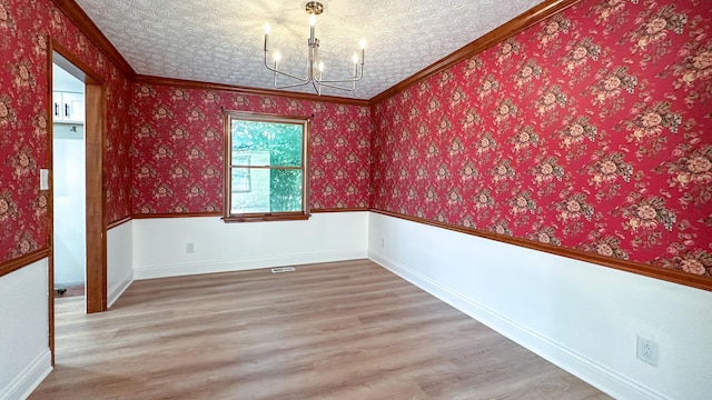 5078 Grassland Dr, Dublin, OH 43016 - spare room with a chandelier, wood finished floors, and ornamental molding