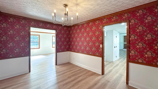 5078 Grassland Dr, Dublin, OH 43016 - unfurnished room with light wood-type flooring, a chandelier, ornamental molding, and wainscoting