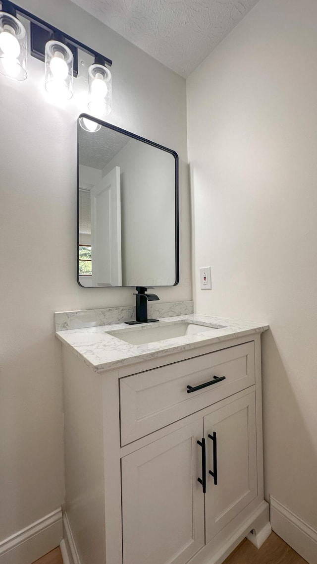 5078 Grassland Dr, Dublin, OH 43016 - bathroom featuring vanity, a textured ceiling, and wood finished floors