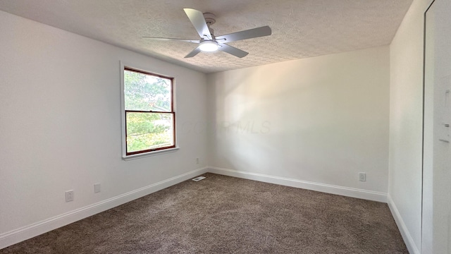 5078 Grassland Dr, Dublin, OH 43016 - spare room featuring a textured ceiling, dark colored carpet, and a ceiling fan