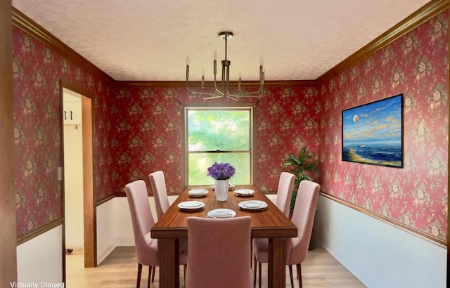 5078 Grassland Dr, Dublin, OH 43016 - dining room featuring light wood finished floors, a chandelier, crown molding, wallpapered walls, and a textured ceiling