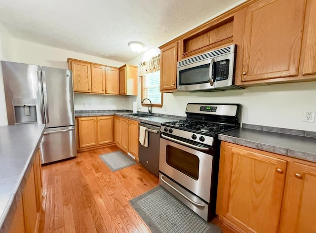 13944 Lafayette Rd, Utica, OH 43080 - kitchen featuring appliances with stainless steel finishes, light wood-style floors, dark countertops, and open shelves
