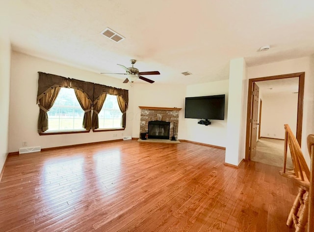 13944 Lafayette Rd, Utica, OH 43080 - unfurnished living room with wood finished floors, a ceiling fan, and a fireplace