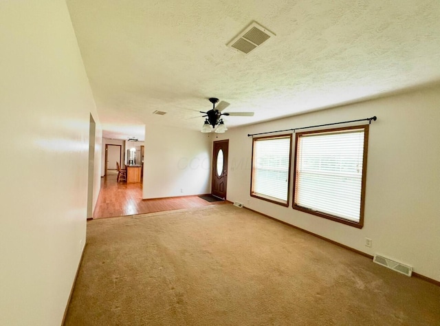 13944 Lafayette Rd, Utica, OH 43080 - spare room featuring carpet flooring, a ceiling fan, and a textured ceiling