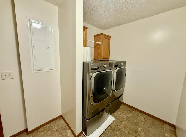 13944 Lafayette Rd, Utica, OH 43080 - laundry area featuring cabinet space, washing machine and clothes dryer, electric panel, and a textured ceiling