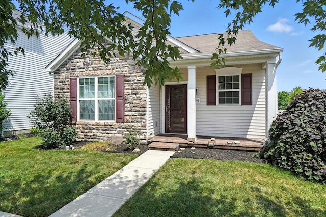5804 Trail Creek Dr, Dublin, OH 43016 - view of front facade with stone siding, a shingled roof, a front lawn, and covered porch