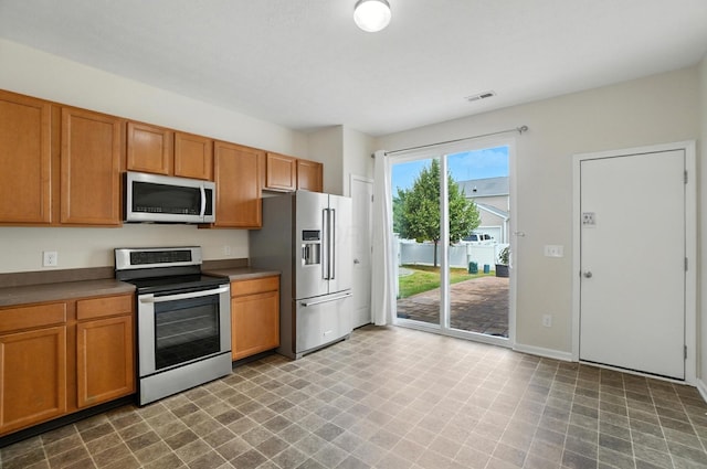 5804 Trail Creek Dr, Dublin, OH 43016 - kitchen featuring stainless steel appliances and brown cabinets