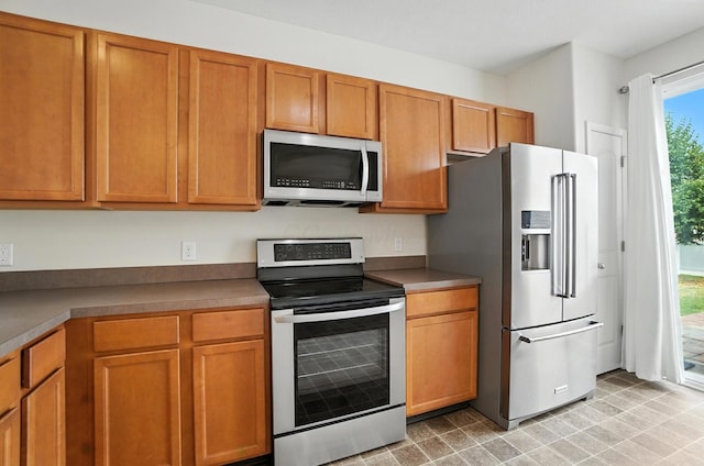 5804 Trail Creek Dr, Dublin, OH 43016 - kitchen featuring appliances with stainless steel finishes and brown cabinets