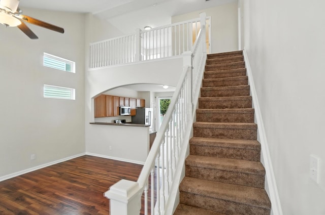 5804 Trail Creek Dr, Dublin, OH 43016 - stairway with wood finished floors, arched walkways, ceiling fan, and a towering ceiling