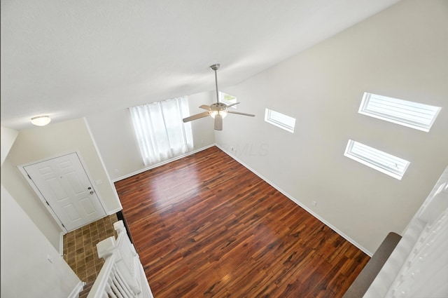 5804 Trail Creek Dr, Dublin, OH 43016 - unfurnished living room with wood finished floors, a ceiling fan, a skylight, and vaulted ceiling