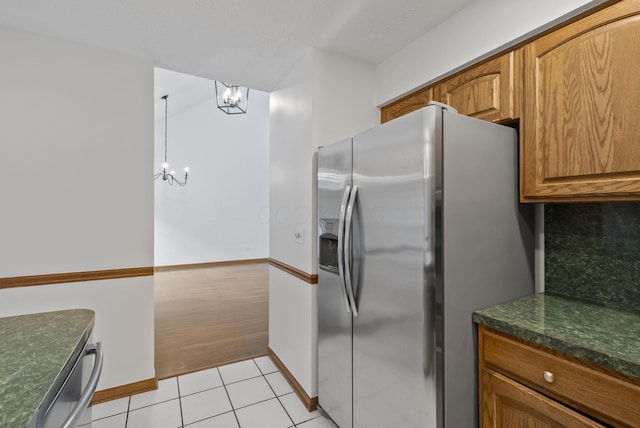 1280 Gemstone Sq W, Westerville, OH 43081 - kitchen with a chandelier, stainless steel fridge, brown cabinetry, light tile patterned floors, and dishwashing machine