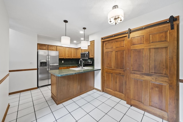 1280 Gemstone Sq W, Westerville, OH 43081 - kitchen featuring dark countertops, a peninsula, appliances with stainless steel finishes, backsplash, and a barn door
