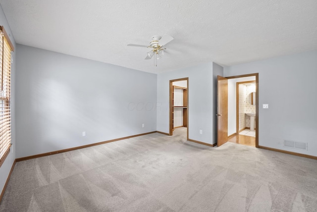 1280 Gemstone Sq W, Westerville, OH 43081 - unfurnished bedroom with a spacious closet, carpet floors, a textured ceiling, and ceiling fan