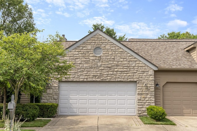 1280 Gemstone Sq W, Westerville, OH 43081 - view of front of house with a shingled roof, concrete driveway, an attached garage, and stone siding
