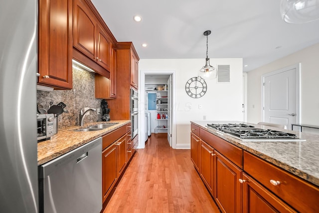 1475 W 3rd Ave Unit 401, Columbus, OH 43212 - kitchen with appliances with stainless steel finishes, decorative backsplash, light stone countertops, light wood-type flooring, and recessed lighting