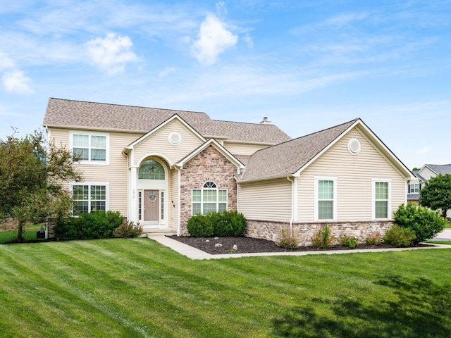 3012 Coltsbridge Dr, Lewis Center, OH 43035 - view of front of property featuring stone siding, a front lawn, and a shingled roof