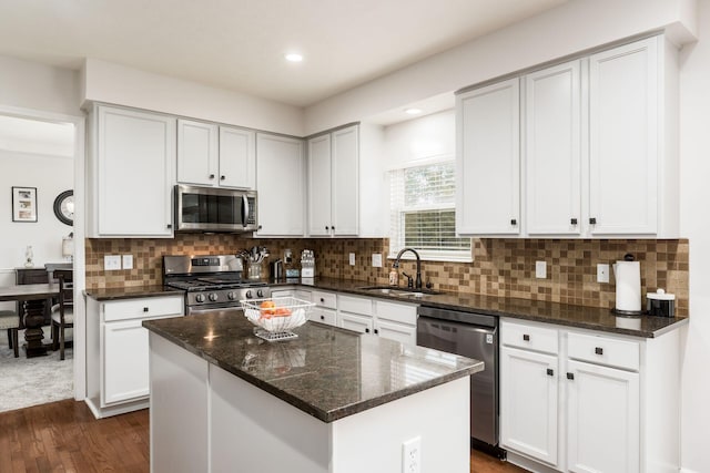 3012 Coltsbridge Dr, Lewis Center, OH 43035 - kitchen featuring stainless steel appliances, dark stone countertops, dark wood-style flooring, tasteful backsplash, and a center island