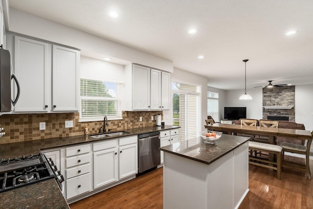 3012 Coltsbridge Dr, Lewis Center, OH 43035 - kitchen featuring tasteful backsplash, open floor plan, ceiling fan, stainless steel appliances, and dark wood-style floors