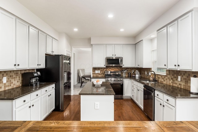 3012 Coltsbridge Dr, Lewis Center, OH 43035 - kitchen with stainless steel appliances, a center island, dark wood-style floors, decorative backsplash, and recessed lighting