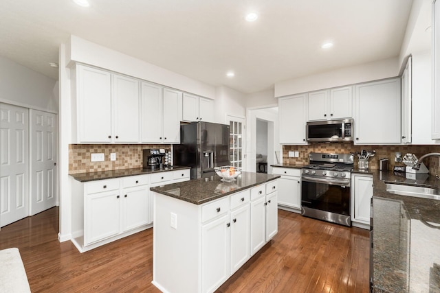 3012 Coltsbridge Dr, Lewis Center, OH 43035 - kitchen featuring stainless steel appliances, dark wood-style flooring, dark stone counters, backsplash, and recessed lighting