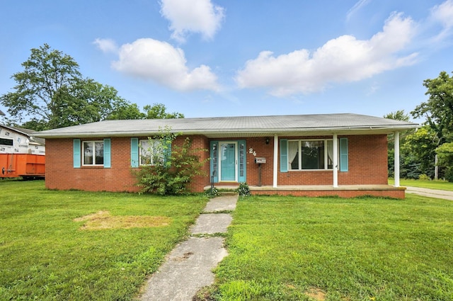 24 W High St, Jeffersonville, OH 43128 - ranch-style home featuring brick siding, a porch, and a front yard