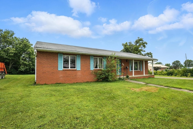 24 W High St, Jeffersonville, OH 43128 - ranch-style house featuring brick siding, a front lawn, and covered porch