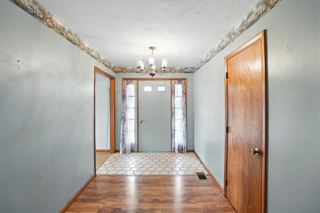 24 W High St, Jeffersonville, OH 43128 - foyer featuring a chandelier and light wood-style flooring