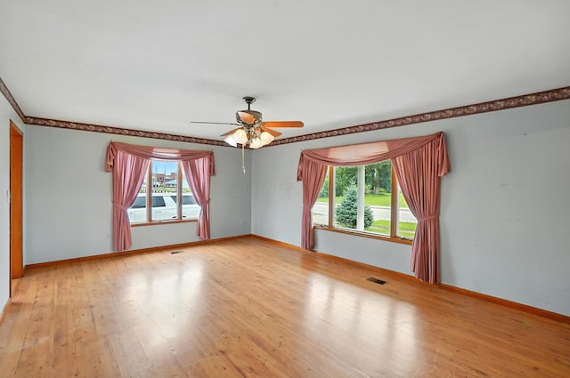 24 W High St, Jeffersonville, OH 43128 - empty room featuring healthy amount of natural light, a ceiling fan, wood finished floors, and ornamental molding