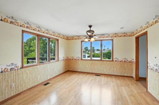 24 W High St, Jeffersonville, OH 43128 - spare room featuring wood finished floors, wainscoting, ceiling fan, and wood walls