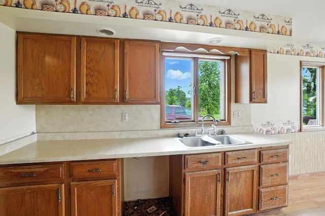 24 W High St, Jeffersonville, OH 43128 - kitchen with light countertops, healthy amount of natural light, and brown cabinetry