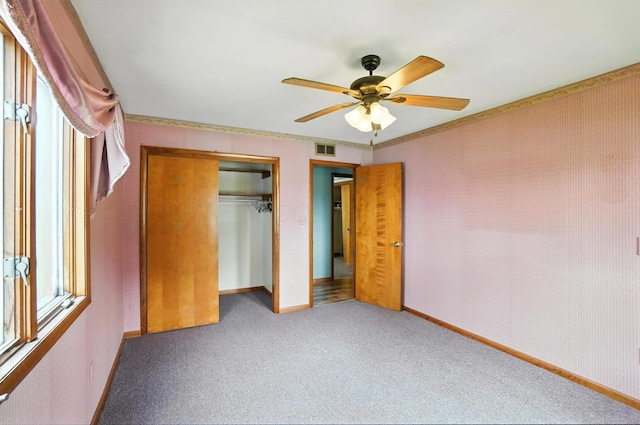 24 W High St, Jeffersonville, OH 43128 - unfurnished bedroom with carpet, a closet, a ceiling fan, and wallpapered walls