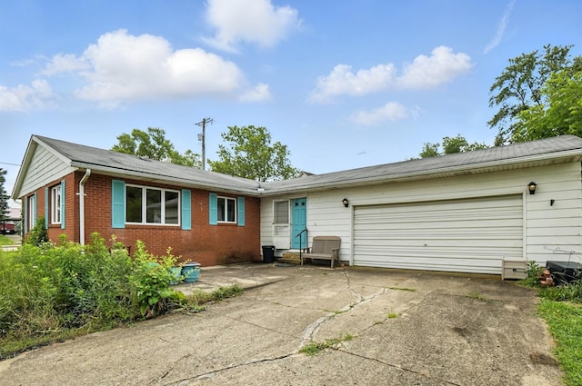 24 W High St, Jeffersonville, OH 43128 - ranch-style home featuring driveway, an attached garage, and brick siding