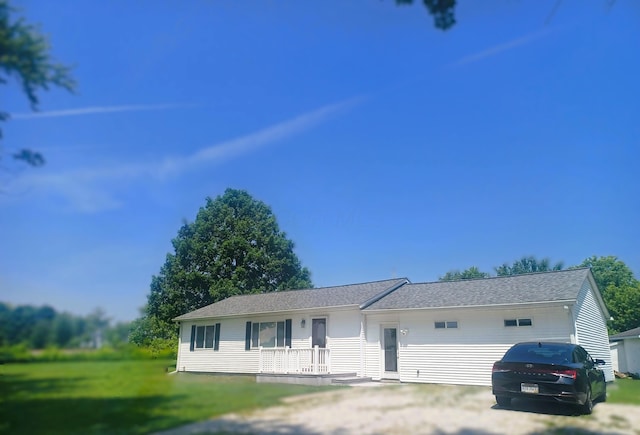 5356 Harding Hwy E, Caledonia, OH 43314 - ranch-style home featuring a front yard, roof with shingles, covered porch, and driveway