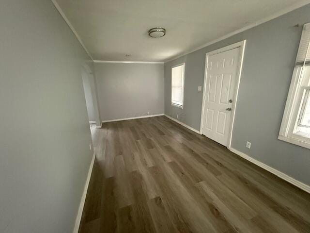 unfurnished living room with crown molding and dark wood-style flooring