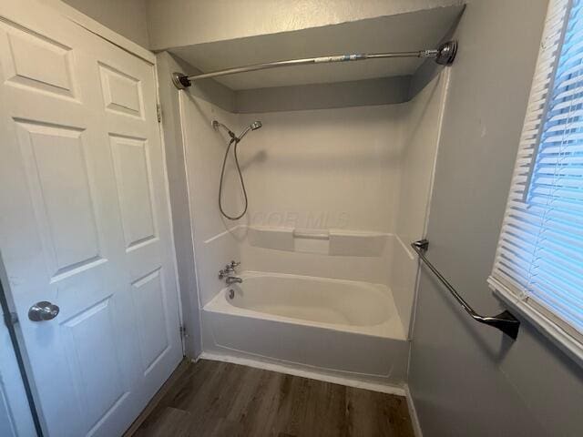 bathroom featuring wood finished floors and shower / bathtub combination