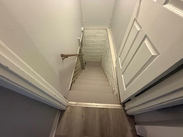 staircase featuring wood finished floors
